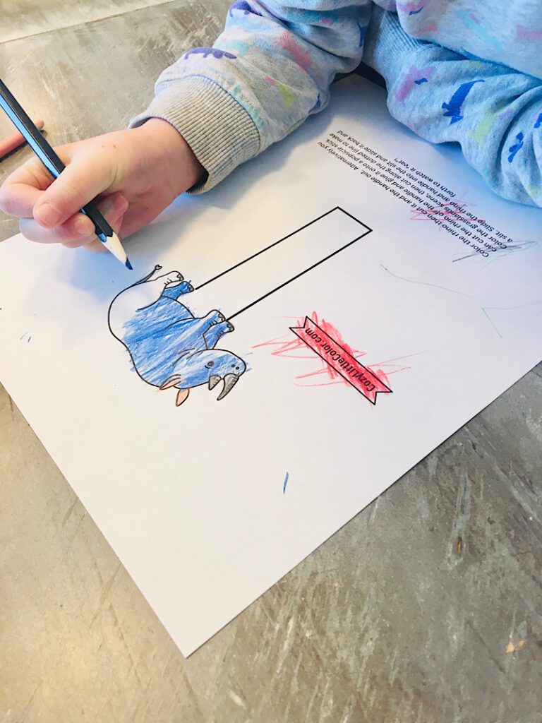 child coloring in a rhino puppet